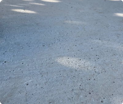 Terrasse en béton terminée avec chaises visibles, après travaux